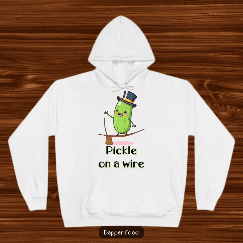 Funny Hoodie: A grinning anthropomorphic pickle character in a top hat wobbles on a tightrope, creating a humorous and cozy apparel item.