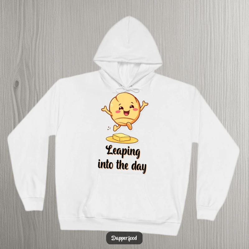 Funny croissant hoodie, a beaming pastry character joyfully jumping over a butter puddle, super cozy and funny gift.
